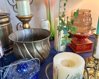 Decorative pillar candle, blue glassware and brass bowl