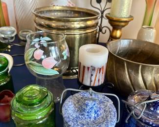 Assorted colored glass jars, brass bowl and candles