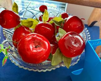Glass bowl with red glass apple ornaments