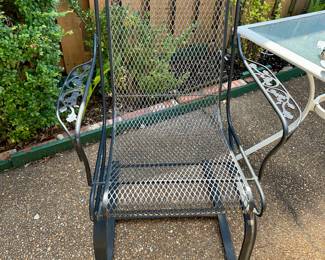 Black wrought iron garden chair with mesh seat
