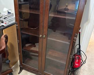 Wooden curio cabinet with glass doors