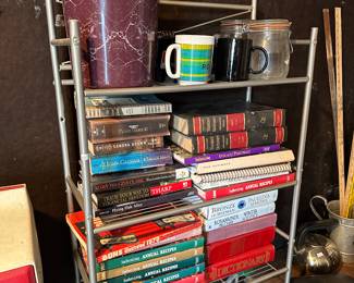 Metal shelving unit with board games and enamel bucket