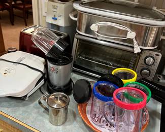 Assorted kitchen appliances and colorful glass tumblers