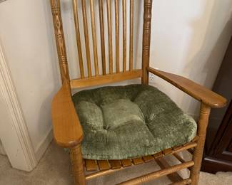 Wooden rocking chair with green cushion