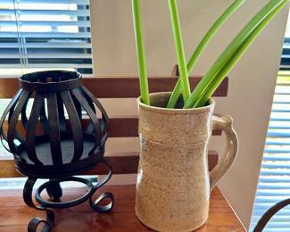 Pottery pitcher with plant stems and black metal lantern