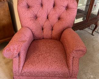 Coral pink tufted upholstered armchair with rolled arms