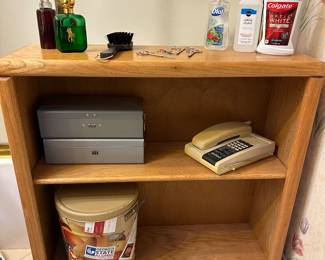 Small wooden bookshelf with shelves and adding machine