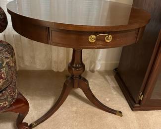 Mahogany round side table with brass pulls