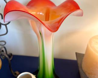 Hand-blown art glass lily-shaped vase with vibrant orange and pink hues; elegant statement piece for any decor.