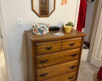 Five-drawer oak chest with brass pulls and wall mirror
