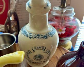 Decorative stoneware jug and purple glass bottle