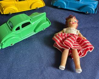 Vintage toy cars and plastic doll