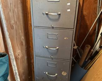 Tall metal file cabinet with multiple drawers