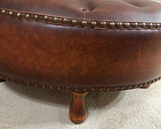 Tufted leather ottoman with nailhead trim