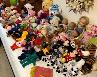 Collection of plush stuffed animals and dolls