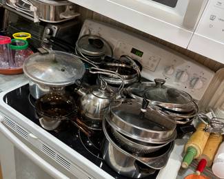 Stovetop with collection of stainless steel pots and pans