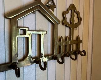 Brass wall-mounted key rack with house motif