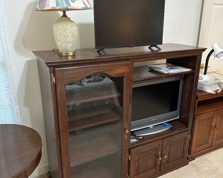 Wood media cabinet with glass doors and TV