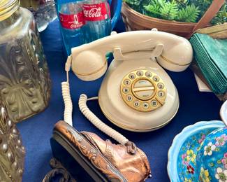 Vintage beige rotary phone with carved wood stand and turquoise dish