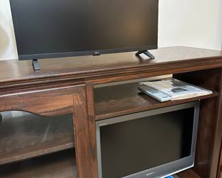 Wood entertainment center with two televisions