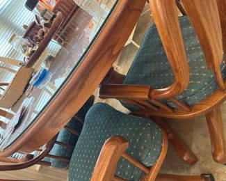Detail of rattan dining chair and glass top table