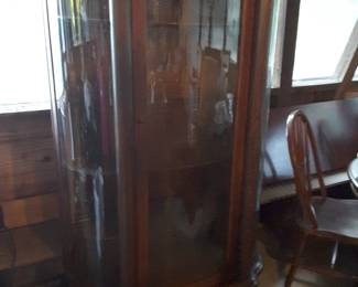 Poor lighting in the building does not do this gorgeous piece of furniture justice. Beautiful antique oak bow front china cabinet with ball & claw feet. Excellent condition!