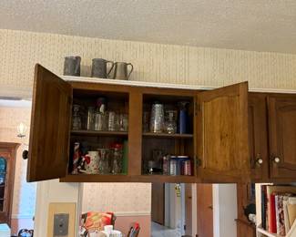 Kitchen stuff, cookbooks and armetal mugs.
