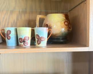 This is a vintage Majolica pitcher and mug set.