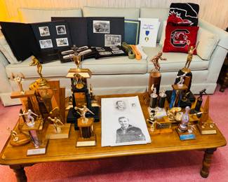 Trophies and copies of articles written on boxer’s winnings.