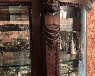 Man's bust carved on other side of cabinet