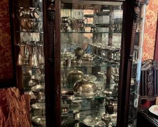 Large carved china cabinet, lots of lovely silver plate serving pieces.
