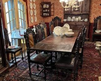 Large dining table, set of chairs with leather seats.