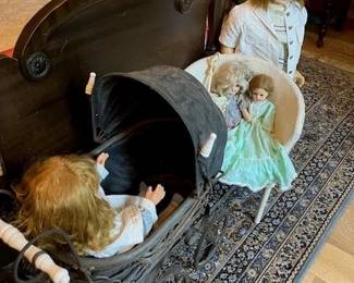 Antique doll buggy, wicker chair, dolls