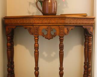 Carved hall table, solid wood. Small water-damaged spot on the top, easily covered by decorative piece.
$100