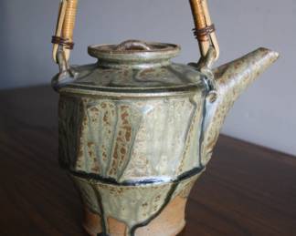 Handcrafted Ceramic Teapot with Bamboo Handle $85. The beautiful hand-glazed teapot features earthy tones, intricate detailing, and a natural bamboo handle.