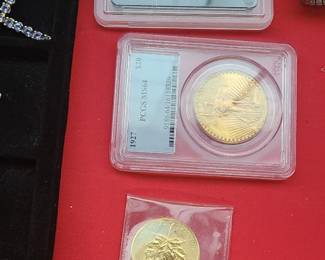 Assorted Gold coins including a $20 and a $5 coin and a 1oz Maple Leaf.