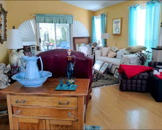 Overview of Living Room. There is a leather recliner, two upholstered sofas, and a small upholstered chair with a matching ottoman.