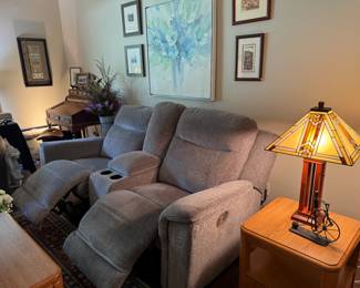 There are two of these couches for sale. Upholstered (textured gray) electric reclining couches with console and cup holders in middle. Like-new and dangerously comfortable!