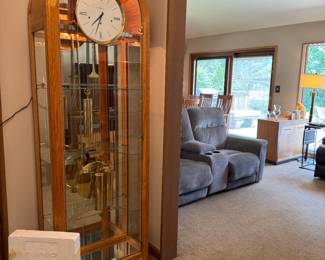 Howard Miller Eternity Curio grandfather clock, post-modern, honey oak, contemporary , lighted. Beautiful! Very unique with the curio shelves inside too