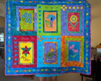 Embroidered quilt that is a wall hanging.
