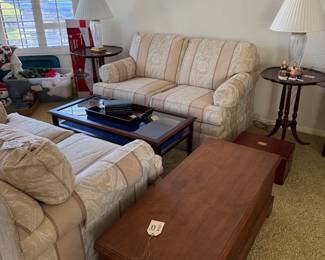 Ethan Allen Loveseats, Custom Glass Display Coffee Table made in England. Pie Crust side Tables, Cedar Chest. Crystal Lamps, Hummels.
