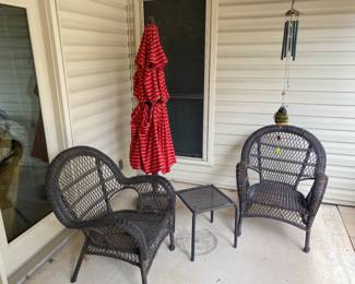 two wicker chairs and table, free standing umbrella on patio