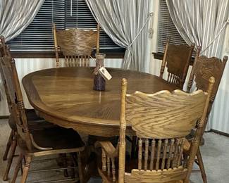 Wood dining set with 2 captain chairs and 4 chairs.