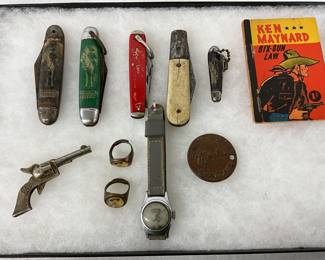 Pocket Knives, Toy Revolver, Rings, Wristwatch, Coin, and Comic Ken Maynard ‘Six-Gun Law’