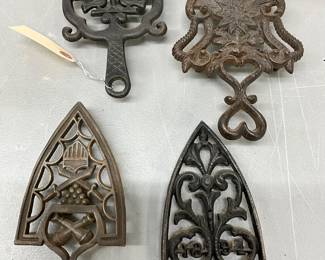 Four Decorative Cast Iron Trivets