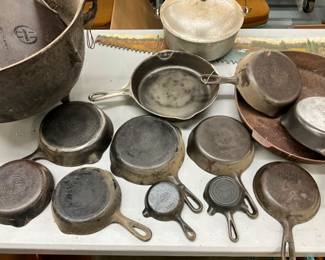 COLLECTION OF CAST IRON PANS