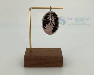 Silver Pendant with Plant and Bird Silhouette Design