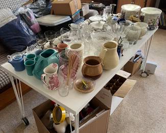 In this picture you can see the collection of pitchers, glassware, and various cups and serving dishes.