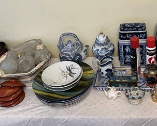 Miscellaneous cups and serving dishes are on this table.