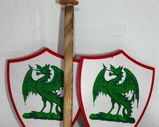Two Dragon Embossed Shields And Sheathed Wooden Sword